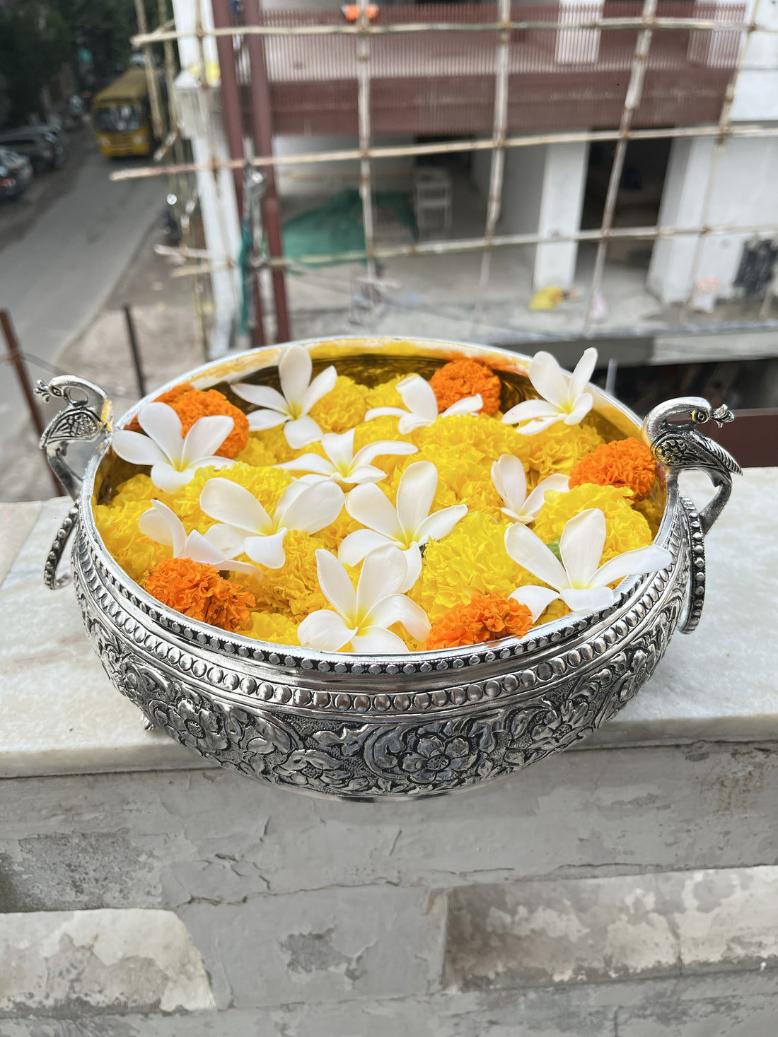 Silver Peacock Handle Urli | Engraved Floral Brass Bowl for Pooja & Festive DécorSilver Peacock Handle Urli | Engraved Floral Brass Bowl for Pooja & Festive Décor